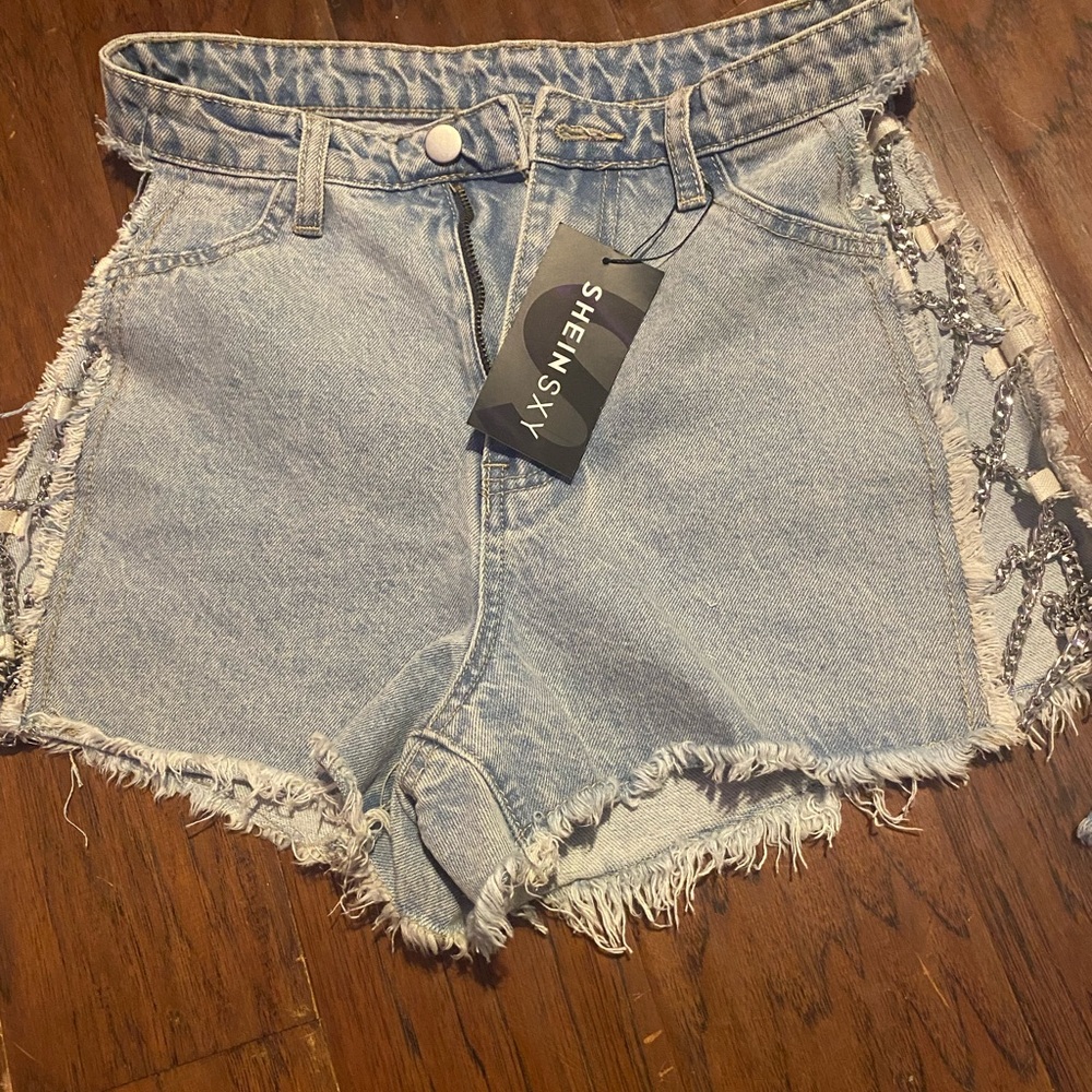 cute jean shorts with cross chains on the sides
